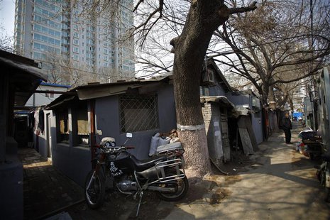 A man stands at an alley next to a residential compound in central Beijing, March 22, 2013. REUTERS/Petar Kujundzic A man stands at an alley next to a residential compound in central Beijing, March 22, 2013. REUTERS/Petar Kujundzic
