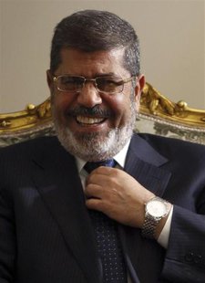 Egypt's President Mohamed Mursi laughs during his meeting with U.S. Secretary of State John Kerry (not pictured) at El-Thadiya presidential Egypt's President Mohamed Mursi laughs during his meeting with U.S. Secretary of State John Kerry (not pictured) at El-Thadiya presidential
