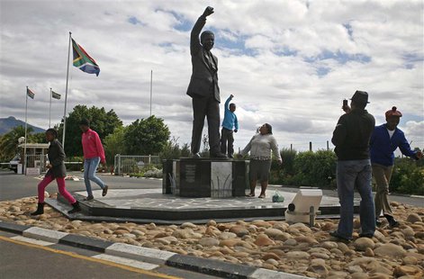 Visitors walk past a statue of former South African president Nelson Mandela outside the Victor Verster Prison near Paarl in the Cape winela Visitors walk past a statue of former South African president Nelson Mandela outside the Victor Verster Prison near Paarl in the Cape winela