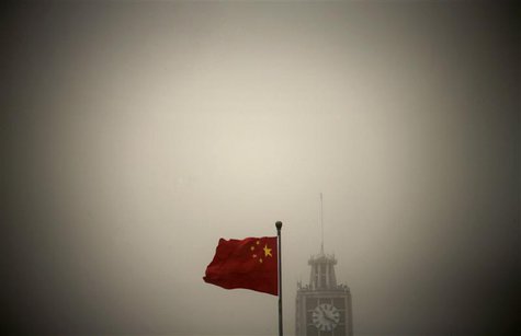 A Chinese national flag flies in front of Beijing Telegraph Building on a hazy morning in central Beijing in this February 28, 2013 file pho A Chinese national flag flies in front of Beijing Telegraph Building on a hazy morning in central Beijing in this February 28, 2013 file pho