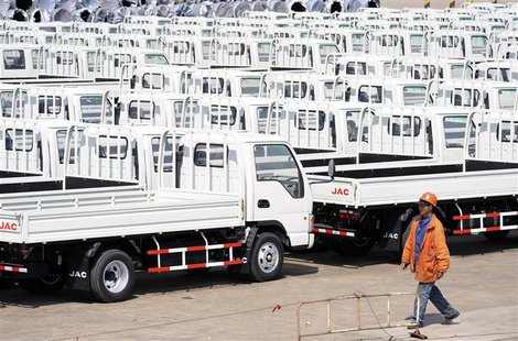 A worker walks past Chinese trucks for exporting at a port of Liangyungang, Jiangsu province, March 31, 2013. China's official manufacturing A worker walks past Chinese trucks for exporting at a port of Liangyungang, Jiangsu province, March 31, 2013. China's official manufacturing