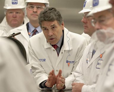 Texas Governor Rick Perry (C) asks a question with Iowa Governor Terry Branstad (R) and Nebraska Lt. Governor Rick Sheehy (2nd R) during a t Texas Governor Rick Perry (C) asks a question with Iowa Governor Terry Branstad (R) and Nebraska Lt. Governor Rick Sheehy (2nd R) during a t