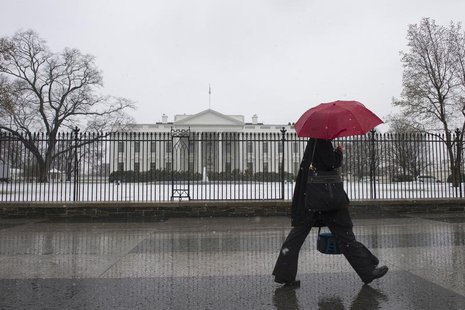 A pedestrian walks down Pennsylvania Avenue past the White House during an early spring snowstorm, in Washington March 25, 2013. REUTERS/Mar A pedestrian walks down Pennsylvania Avenue past the White House during an early spring snowstorm, in Washington March 25, 2013. REUTERS/Mar