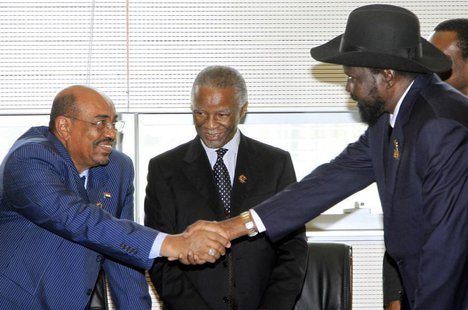 Sudan's President Omar Hassan al-Bashir (L) shakes hands with South Sudan's President Salva Kiir as African Union mediator and former South Sudan's President Omar Hassan al-Bashir (L) shakes hands with South Sudan's President Salva Kiir as African Union mediator and former South