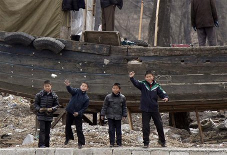 Children throw stones into Yalu River, at the river banks, near the North Korean town of Sinuiju, opposite the Chinese border city of Dandon Children throw stones into Yalu River, at the river banks, near the North Korean town of Sinuiju, opposite the Chinese border city of Dandon
