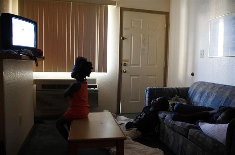 Children watch television inside a motel room in Grand Prairie, Texas July 2, 2009. REUTERS/Jessica Rinaldi Children watch television inside a motel room in Grand Prairie, Texas July 2, 2009. REUTERS/Jessica Rinaldi