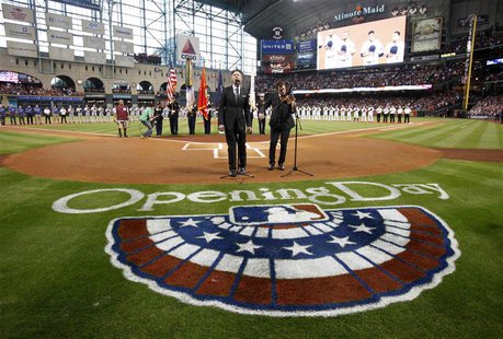 Singer Lyle Lovett and fiddler Luke Bulla play the national anthem before the Houston Astros play the Texas Rangers on opening night of the Singer Lyle Lovett and fiddler Luke Bulla play the national anthem before the Houston Astros play the Texas Rangers on opening night of the