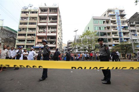 Police stand near a mosque and school dormitory that were damaged by a fire in Yangon April 2, 2013. REUTERS/Soe Zeya Tun Police stand near a mosque and school dormitory that were damaged by a fire in Yangon April 2, 2013. REUTERS/Soe Zeya Tun
