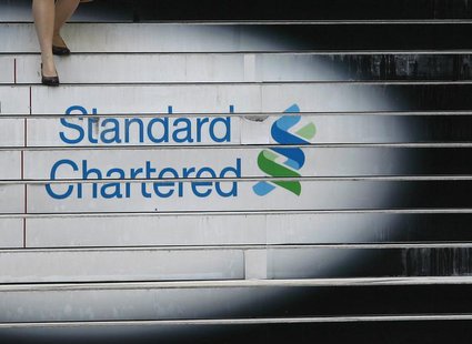 A woman walks down the stairs of the Standard Chartered headquarters in Hong Kong October 13, 2010. REUTERS/Bobby Yip A woman walks down the stairs of the Standard Chartered headquarters in Hong Kong October 13, 2010. REUTERS/Bobby Yip
