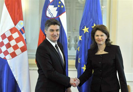 Slovenian Prime Minister Alenka Bratusek (R) shakes hands with her Croatian counterpart Zoran Milanovic before the Slovenian parliament is e Slovenian Prime Minister Alenka Bratusek (R) shakes hands with her Croatian counterpart Zoran Milanovic before the Slovenian parliament is e
