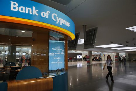 A woman working at Larnaca's airport walks past a small branch of the Bank of Cyprus inside the airport March 31, 2013. REUTERS/Yorgos Karah A woman working at Larnaca's airport walks past a small branch of the Bank of Cyprus inside the airport March 31, 2013. REUTERS/Yorgos Karah
