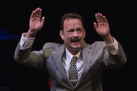 Actor Tom Hanks gestures to the audience after his performance in the premiere of the play Lucky Guy in New York, April 1, 2013. REUTERS/Luc Actor Tom Hanks gestures to the audience after his performance in the premiere of the play Lucky Guy in New York, April 1, 2013. REUTERS/Luc