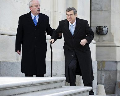 U.S. Senator Mark Kirk (R-IL)(R) walks up steps to the Senate Chamber with the assistance of an aide on his return to the U.S. Senate on Cap U.S. Senator Mark Kirk (R-IL)(R) walks up steps to the Senate Chamber with the assistance of an aide on his return to the U.S. Senate on Cap