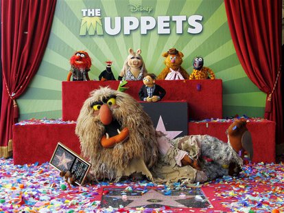 Muppet character Sweetums holds a commemorative plaque as he lies beside the newly unveiled Muppets star as other Mupetts background (L-R) A Muppet character Sweetums holds a commemorative plaque as he lies beside the newly unveiled Muppets star as other Mupetts background (L-R) A
