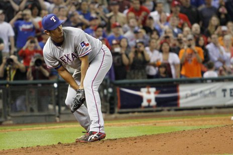 Texas Rangers pitcher Yu Darvish watches after a hit by Houston Astros' Marwin Gonzalez goes through his legs and he lost his perfect game w Texas Rangers pitcher Yu Darvish watches after a hit by Houston Astros' Marwin Gonzalez goes through his legs and he lost his perfect game w