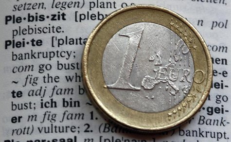 An one Euro coin is pictured next to the words bankruptcy (pleite) in an English-German dictionary in Munich February 10, 2012. REUTERS/Mich An one Euro coin is pictured next to the words bankruptcy (pleite) in an English-German dictionary in Munich February 10, 2012. REUTERS/Mich