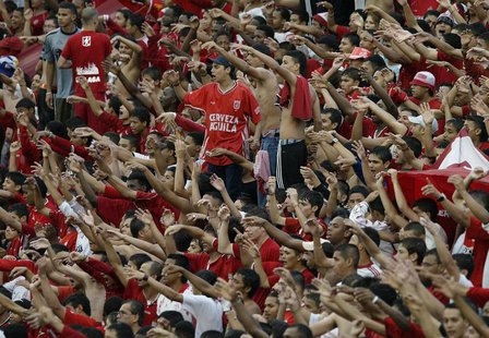 Fans of the America team chant from the stands as their team walks onto the pitch at Pascual Guerrero stadium in Cali March 1, 2009. Colombi Fans of the America team chant from the stands as their team walks onto the pitch at Pascual Guerrero stadium in Cali March 1, 2009. Colombi