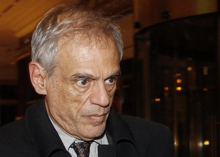 Cypriot Finance Minister Michael Sarris (front) walks at a hotel lobby after arriving from the Russian Finance Ministry headquarters in Mosc Cypriot Finance Minister Michael Sarris (front) walks at a hotel lobby after arriving from the Russian Finance Ministry headquarters in Mosc