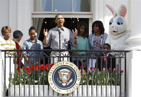 U.S. President Barack Obama speaks alongside first lady Michelle (2nd R), their daughters Sasha (2nd L) and Malia (3rd R), Michelle Obama's U.S. President Barack Obama speaks alongside first lady Michelle (2nd R), their daughters Sasha (2nd L) and Malia (3rd R), Michelle Obama's