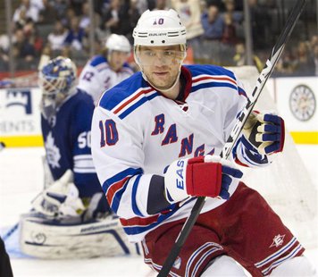 New York Rangers Marian Gaborik skattes into the corner after scoring his second goal on Toronto Maple Leafs goalie Jonas Gustavsson (L) in New York Rangers Marian Gaborik skattes into the corner after scoring his second goal on Toronto Maple Leafs goalie Jonas Gustavsson (L) in