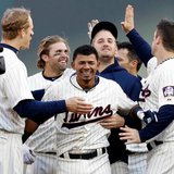 Minnesota Twins shortstop Eduardo Escobar (c) is congratulated by teammates Justin Morneau (l), Joe Mauer (r) and others following his game-winning, two-run double in the ninth inning of a 3-2 victory over visiting Detroit at Target Field in Minneapolis on Apr. 3, 2013. (photo courtesy Minnesota Twins) Minnesota Twins shortstop Eduardo Escobar (c) is congratulated by teammates Justin Morneau (l), Joe Mauer (r) and others following his game-winning, two-run double in the ninth inning of a 3-2 victory over visiting Detroit at Target Field in Minneapolis on Apr. 3, 2013. (photo courtesy Minnesota Twins)