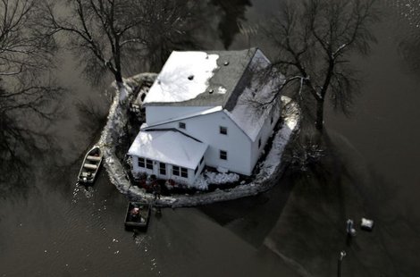 An aerial view shows a house with a sandbag levee is surrounded by floodwaters south of Fargo, North Dakota in this file photo taken March 2 An aerial view shows a house with a sandbag levee is surrounded by floodwaters south of Fargo, North Dakota in this file photo taken March 2