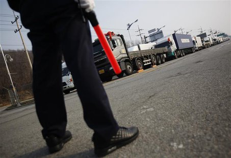 A South Korean security guard keeps watch as South Korean trucks wait to enter the Kaesong industrial complex in North Korea, at the South's A South Korean security guard keeps watch as South Korean trucks wait to enter the Kaesong industrial complex in North Korea, at the South's