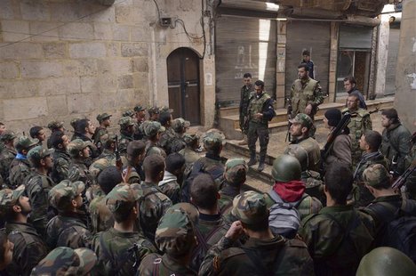 Forces loyal to Syria's President Bashar al-Assad get briefed before being deployed from the al-Sabaa Bahrat district to the old souk of Ale Forces loyal to Syria's President Bashar al-Assad get briefed before being deployed from the al-Sabaa Bahrat district to the old souk of Ale