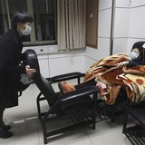 A patient with fever (R) is accompanied by a family member while receiving treatment at the hospital where a 67-year-old H7N9 patient is bei A patient with fever (R) is accompanied by a family member while receiving treatment at the hospital where a 67-year-old H7N9 patient is bei