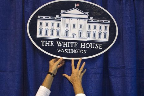 A volunteer adjusts a sign at the America Presidential Experience exhibit during the Democratic National Convention in Charlotte, North Caro A volunteer adjusts a sign at the America Presidential Experience exhibit during the Democratic National Convention in Charlotte, North Caro