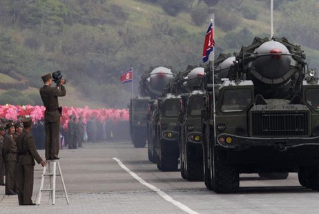 A North Korean soldier films military vehicles carrying missiles during a parade to commemorate the 65th anniversary of founding of the Work A North Korean soldier films military vehicles carrying missiles during a parade to commemorate the 65th anniversary of founding of the Work