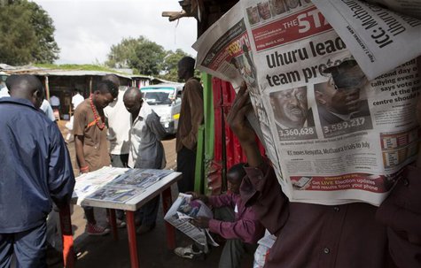 A man reads the morning edition of The Standard newspaper showing provisional results for the two main presidential election contenders in t A man reads the morning edition of The Standard newspaper showing provisional results for the two main presidential election contenders in t