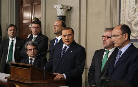Italy's former Prime Minister Silvio Berlusconi (C) speaks to reporters after a meeting with Italian President Giorgio Napolitano at Quirina Italy's former Prime Minister Silvio Berlusconi (C) speaks to reporters after a meeting with Italian President Giorgio Napolitano at Quirina