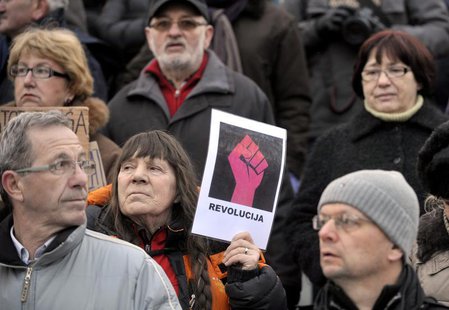 A protester holds a sign during an anti-austerity and anti-corruption protest in Ljubljana February 8, 2013. REUTERS/Srdjan Zivulovic A protester holds a sign during an anti-austerity and anti-corruption protest in Ljubljana February 8, 2013. REUTERS/Srdjan Zivulovic