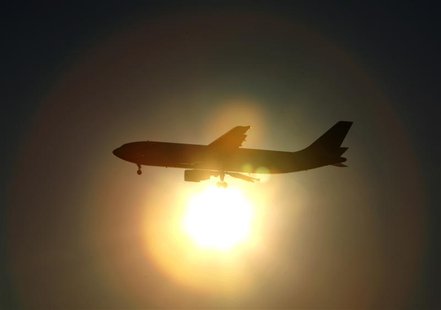 A Japan Airlines (JAL) aircraft is silhouetted against the setting sun as it prepares to land at Haneda airport in Tokyo January 17, 2010. R A Japan Airlines (JAL) aircraft is silhouetted against the setting sun as it prepares to land at Haneda airport in Tokyo January 17, 2010. R