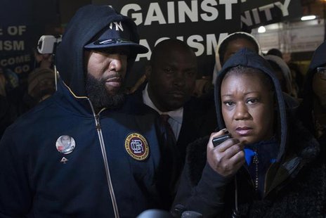 Tracy Martin (L) and Sybrina Fulton, the parents of Trayvon Martin, participate in a candlelight vigil to mark the anniversary of the shooti Tracy Martin (L) and Sybrina Fulton, the parents of Trayvon Martin, participate in a candlelight vigil to mark the anniversary of the shooti