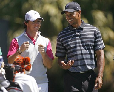 Rory McIlroy (L), of Northern Ireland shares a laugh with his playing partner Tiger Woods on the 12th tee during first round play in the 201 Rory McIlroy (L), of Northern Ireland shares a laugh with his playing partner Tiger Woods on the 12th tee during first round play in the 201