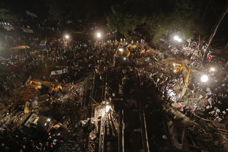 Rescue workers search for survivors at the site of a collapsed residential building in Thane, on the outskirts of Mumbai April 4, 2013. At l Rescue workers search for survivors at the site of a collapsed residential building in Thane, on the outskirts of Mumbai April 4, 2013. At l