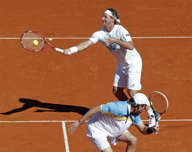 Argentina's David Nalbandian (rear) and Horacio Zeballos compete in their Davis Cup doubles quarter-final tennis match against France's Juli Argentina's David Nalbandian (rear) and Horacio Zeballos compete in their Davis Cup doubles quarter-final tennis match against France's Juli