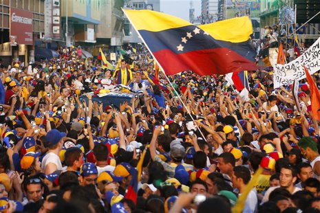 Venezuela's opposition leader and presidential candidate Henrique Capriles (C) greets supporters during a campaign rally in the state of Tac Venezuela's opposition leader and presidential candidate Henrique Capriles (C) greets supporters during a campaign rally in the state of Tac