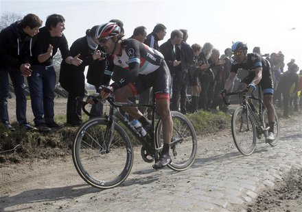 Fabian Cancellara of Switzerland (L) cycles on a cobble-stoned section during the Paris-Roubaix cycling race from Compiegne to Roubaix, Apri Fabian Cancellara of Switzerland (L) cycles on a cobble-stoned section during the Paris-Roubaix cycling race from Compiegne to Roubaix, Apri