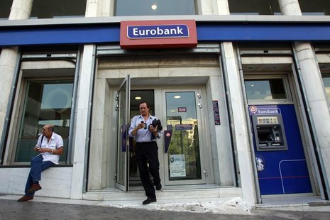 A man comes out of an Eurobank branch in central Athens October 5, 2012. REUTERS/John Kolesidis A man comes out of an Eurobank branch in central Athens October 5, 2012. REUTERS/John Kolesidis