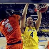 Michigan Wolverines forward Mitch McGary (4) dunks on Syracuse Orange forward Jerami Grant (3) in the first half of their NCAA men's Final Four basketball game in Atlanta, Georgia April 6, 2013. Reuters/Daniel J. Beauvais-Pool 
