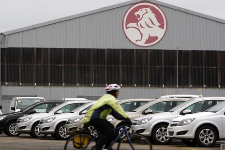 A cyclist rides past a General Motors (GM) Holden storage facility in Melbourne June 2, 2009. REUTERS/Mick Tsikas (AUSTRALIA TRANSPORT BUSIN A cyclist rides past a General Motors (GM) Holden storage facility in Melbourne June 2, 2009. REUTERS/Mick Tsikas (AUSTRALIA TRANSPORT BUSIN