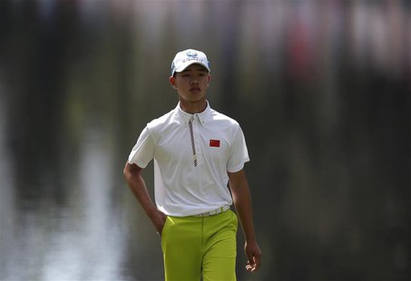 Asia-Pacific Amateur Championship winner, 14 year old Guan Tianlang of China walks on the 16th green during a practice round in preparation Asia-Pacific Amateur Championship winner, 14 year old Guan Tianlang of China walks on the 16th green during a practice round in preparation