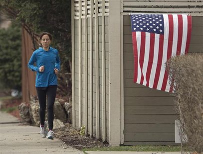 A jogger runs past a U.S. flag near the home of diplomat Anne Smedinghoff, 25, in River Forest, Illinois, April 8, 2013. REUTERS/John Gress A jogger runs past a U.S. flag near the home of diplomat Anne Smedinghoff, 25, in River Forest, Illinois, April 8, 2013. REUTERS/John Gress