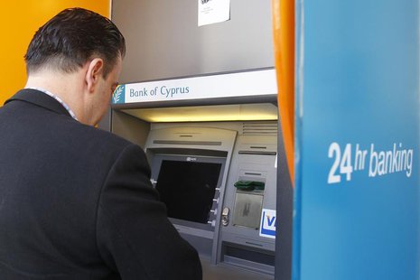 A man withdraws money from an ATM at a branch of Bank of Cyprus in Bucharest April 1, 2013. REUTERS/Bogdan Cristel A man withdraws money from an ATM at a branch of Bank of Cyprus in Bucharest April 1, 2013. REUTERS/Bogdan Cristel