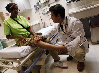 Patient Sharon Dawson Coates has her knee examined by Dr. Narang at University of Chicago Medicine Urgent Care Clinic in Chicago, June 28, 2 Patient Sharon Dawson Coates has her knee examined by Dr. Narang at University of Chicago Medicine Urgent Care Clinic in Chicago, June 28, 2