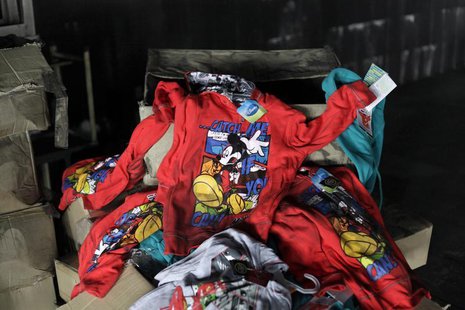 Clothes printed with Disney characters are seen among debris in the Tazreen Fashions garment factory, where 112 workers died in a devastatin Clothes printed with Disney characters are seen among debris in the Tazreen Fashions garment factory, where 112 workers died in a devastatin