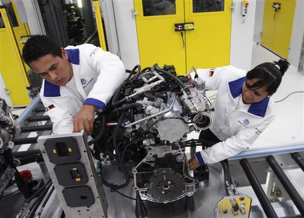 Technicians work on an engine during a media tour at the inauguration of Volkswagen's 100th plant worldwide in Silao in this January 15, 201 Technicians work on an engine during a media tour at the inauguration of Volkswagen's 100th plant worldwide in Silao in this January 15, 201